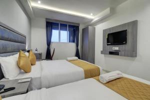 Postel nebo postele na pokoji v ubytování Hotel Isra International, BKC