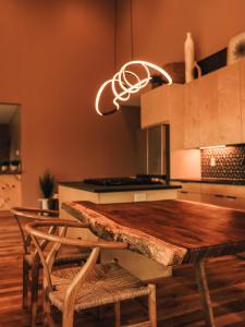 a kitchen with a wooden table with chairs and a light at Long View Resort Bryson City, NC in Bryson City +33 photos