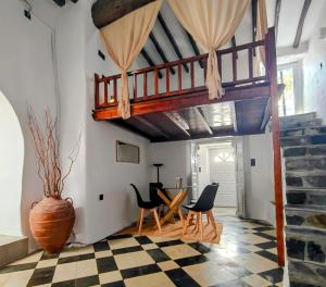 a living room with a staircase and a table and chairs at Frida' s Mansion in Dhragoulás