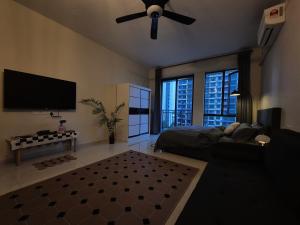 a living room with a couch and a ceiling fan at Central Park Cozy Garden View Studio for 3 pax in Johor Bahru +21 photos