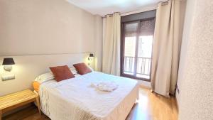 a bedroom with a bed and a large window at campezo in Madrid +17 photos