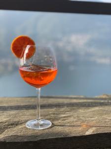 a glass of wine with an orange slice in it at Ristorante Hotel Falchetto in Brunate