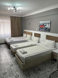 A bed or beds in a room at Mara Suite Taxim