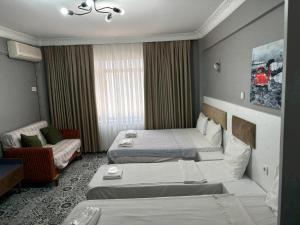 A bed or beds in a room at Mara Suite Taxim