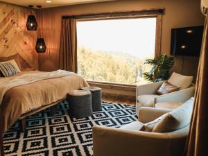 a bedroom with a bed and a couch and a window at Long View Resort Bryson City, NC in Bryson City