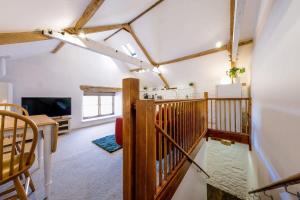 a room with a staircase and a living room at The Cottage- Hopewell in Bristol