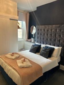 a bedroom with a large bed with two towels on it at Rooms at 153 ROOM ONLY in Scarborough