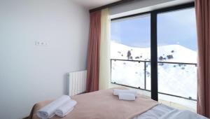 Postel nebo postele na pokoji v ubytování 1BR Apartment in Twins Gudauri project