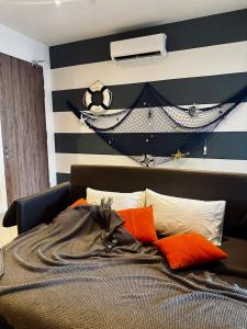 a bedroom with a black and white striped wall at The Shore by D' Hannah Suite - Seaview in Kota Kinabalu
