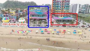 a group of people on a beach with umbrellas at IB306 Tự doanh - Flamingo Hải Tiến in Thanh Hóa