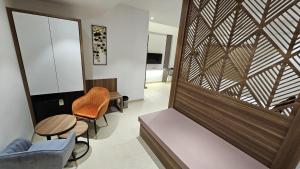 a living room with a partition with a wooden wall at Hotel veesons executive in Solapur