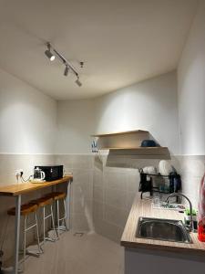 a kitchen with a sink and a counter top at The Shore by D' Hannah Suite - Seaview in Kota Kinabalu