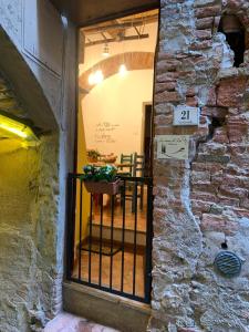 a door to a restaurant with a table in a brick wall at Casina di Lia in Peccioli