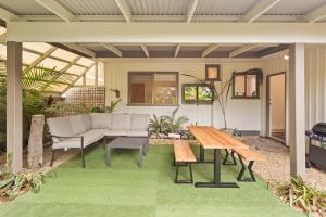 un patio avec un canapé et une table dans l'établissement Tranquil House 3 bed - 2 Bath WI-FI, à Cowes