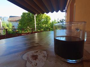 a glass of wine sitting on a table at Casa Tudor Turda in Turda