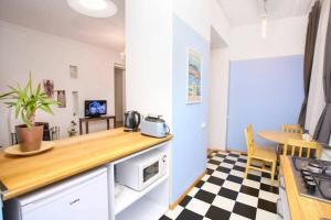 a kitchen with a counter top and a table at Opera House 2BR Apt with Tbilisi Charm - By Wehost in Tbilisi City