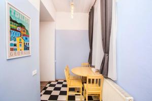 a dining room with a table and chairs at Opera House 2BR Apt with Tbilisi Charm - By Wehost in Tbilisi City