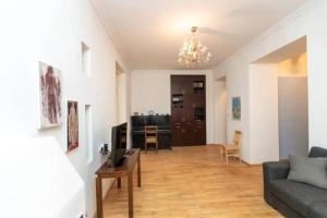 a living room with a couch and a table at Opera House 2BR Apt with Tbilisi Charm - By Wehost in Tbilisi City