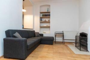 a living room with a couch and a fireplace at Opera House 2BR Apt with Tbilisi Charm - By Wehost in Tbilisi City