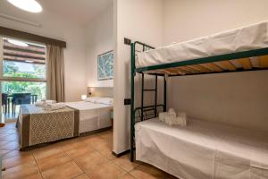 A bed or beds in a room at Residence Le Vele