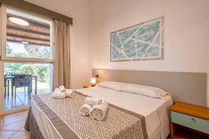 A bed or beds in a room at Residence Le Vele