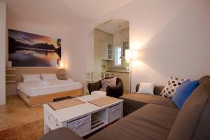 a living room with a couch and a bed at Apartment Dositej 3 in Belgrade