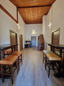 a room with tables and benches and a stove at Apartmani & Auto kamp GAJ in Gacko