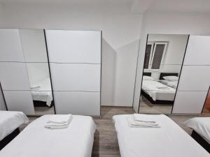 a room with two beds and a mirror at Apartmani & Auto kamp GAJ in Gacko