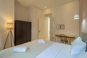 a bedroom with a bed with two towels on it at Stylish 2BR Apt in Tbilisi - By Wehost in Tbilisi City