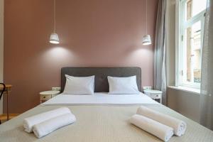 a bedroom with a bed with two towels on it at Stylish 2BR Apt in Tbilisi - By Wehost in Tbilisi City