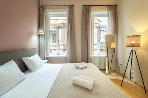 a bedroom with a bed with two towels on it at Stylish 2BR Apt in Tbilisi - By Wehost in Tbilisi City
