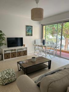 ル・ラヴァンドゥーにあるAppartement L'Anjaure - Lavandouのソファとテーブルのあるリビングルーム