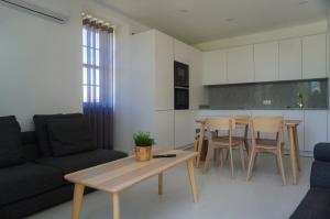 a living room with a couch and a table at Alojamento Fortaleza in Valença