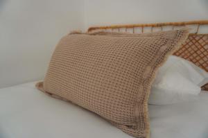 a pillow sitting on top of a bed at Alojamento Fortaleza in Valença