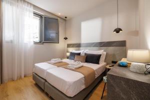 Postel nebo postele na pokoji v ubytování Jolly Suites