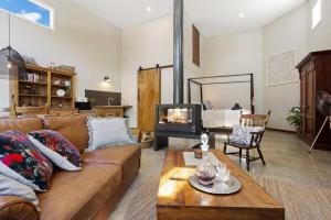a living room with a couch and a fireplace at The Ancient Mariner Retreat in Cape Woolamai