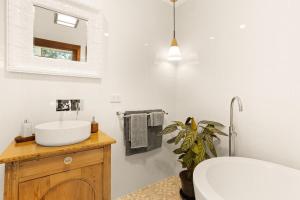 a bathroom with a sink and a toilet and a mirror at The Ancient Mariner Retreat in Cape Woolamai +10 photos