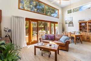 a living room with a couch and a table at The Ancient Mariner Retreat in Cape Woolamai