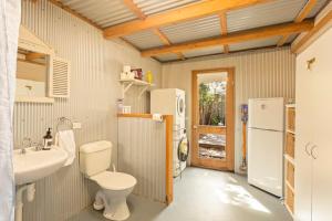 a bathroom with a toilet and a sink and a refrigerator at Kilara Cottage 3-Bed 2-Bath in Cowes +23 photos