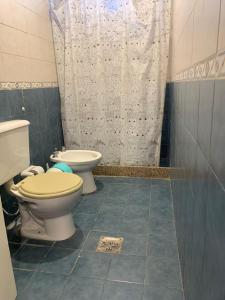 a bathroom with two toilets and a shower at DEPARTAMENTO CAROLA in San Juan +14 photos