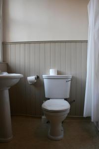 a bathroom with a white toilet and a sink at Royal Mile Budget Apartments in Edinburgh