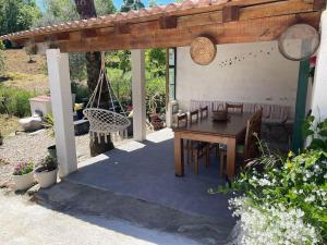 a patio with a wooden pergola and a table and chairs at Casa dos Invernos in Paçô +30 photos