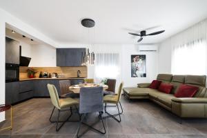 a living room with a couch and a table at Luma 2 Luxury House on the Beach in Murter