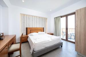 Ένα ή περισσότερα κρεβάτια σε δωμάτιο στο Stella Maris Village