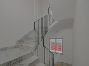 a staircase with a window on the side of a building at Hotel O Royal Palace in Kolkata