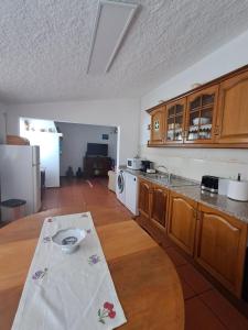 a kitchen with a table in the middle of it at Sweet Living Alentejo in Brinches +20 photos