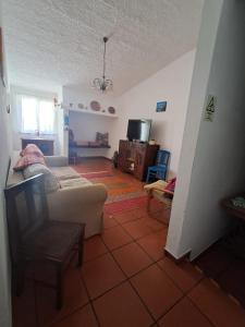 a living room with a couch and a tv at Sweet Living Alentejo in Brinches