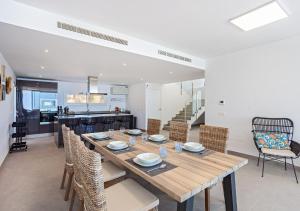 a dining room with a wooden table and chairs at Villa BuenaVista Hills - Sea View - Infinity Pool - Parking - Grill in Málaga