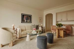 a living room with a couch and a table at The Maybourne Beverly Hills, Maybourne in Los Angeles +134 photos