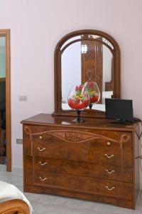 a dresser with a mirror on top of it at Giardino Darianna in Ripacandida +14 photos